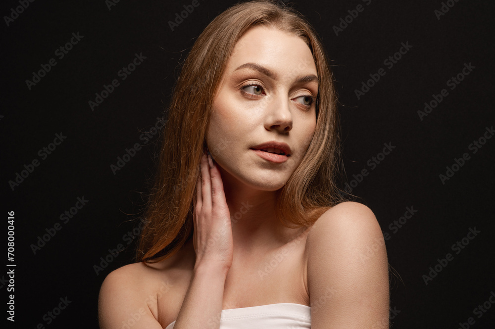 Beauty portrait of a beautiful blonde girl on an isolated black background. Skin care Beauty portrait of a beautiful blonde girl on an isolated black background. Skin care