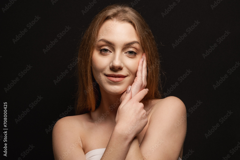 Beauty portrait of a pretty blonde woman posing on a black background. Skin care concept Beauty portrait of a pretty blonde woman posing on a black background. Skin care concept