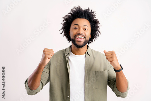 Extremely excited overjoyed man with beard shouting making yes gesture, amazed with his victory, triumph. Indoor studio shot isolated on white background