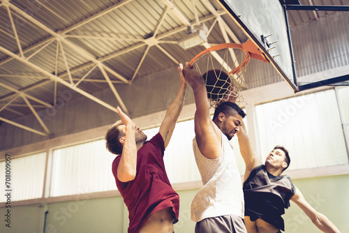 Young men playing basketball indoors photo