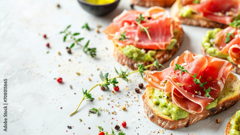 sandwich with guacamole and prosciutto on white background
