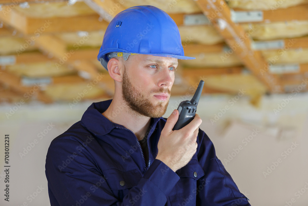 portrait of construction manager using walkie-talkie