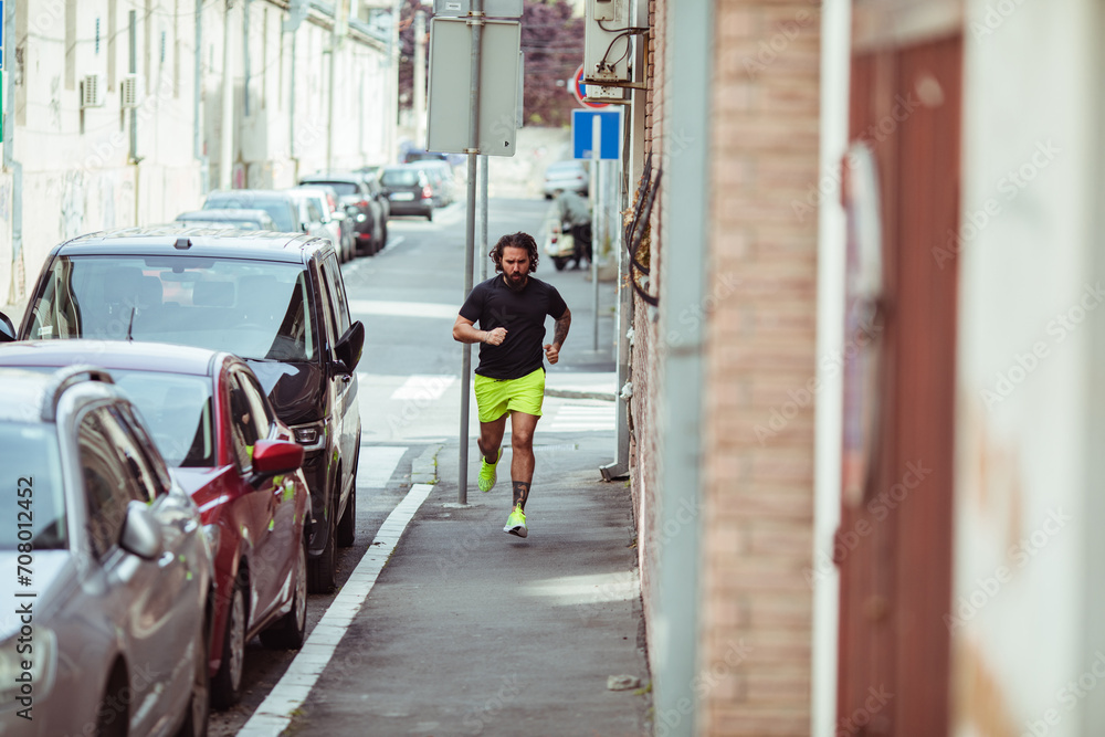 Man jogging in urban alley