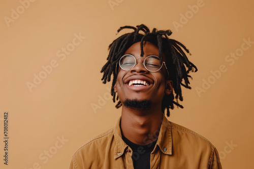 african-american boy smiling on orange background