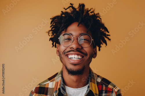 african-american boy smiling on orange background © Jose Tirado