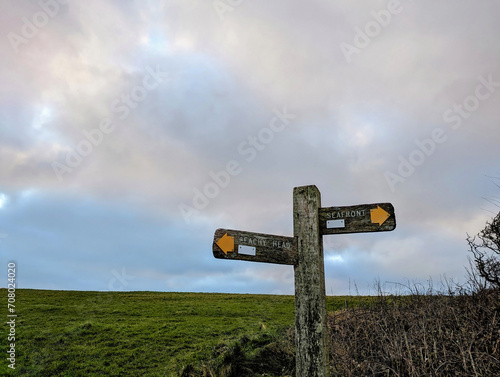 Direction footpath signs on the South Downs pointing to Beachy Head and the Seafront