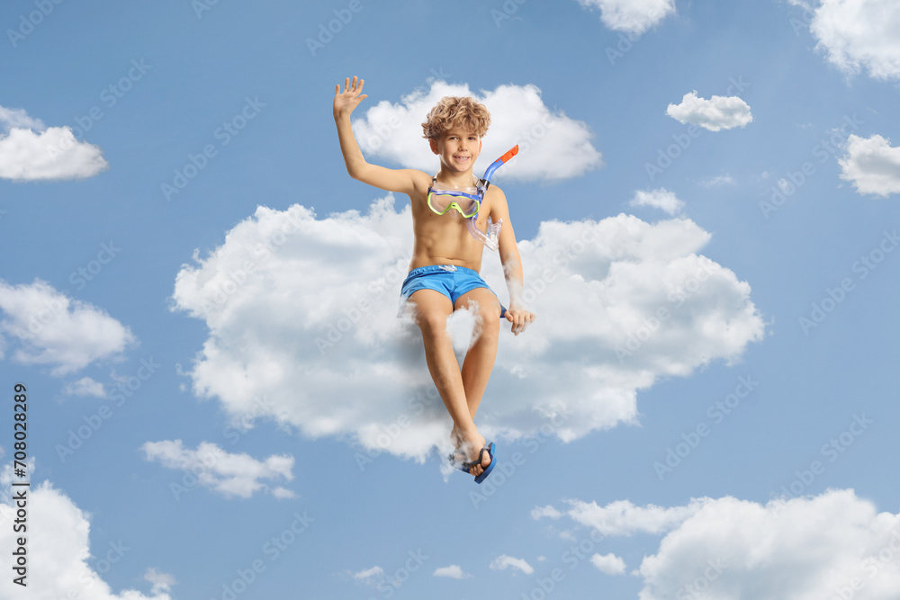 Boy in swimming shorts and a diving mask sitting on a cloud Boy in swimming shorts and a diving mask sitting on a cloud