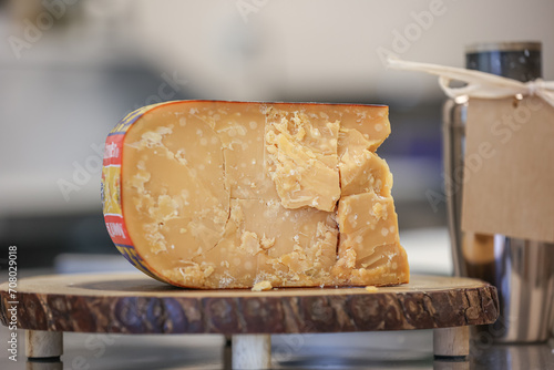 A wedge of Noord Hollander Cheese sits on display inside a cheese shop.