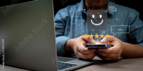 human hand using smartphone with pop-up five star icon for feedback service satisfaction Customer Service Experience and Business Satisfaction Surveys Communication and giving good advice to customers
