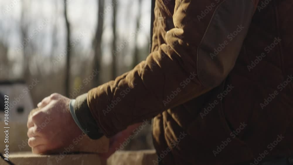 Man unloading bricks from a pickup truck and building an outdoor fire pit Man unloading bricks from a pickup truck and building an outdoor fire pit