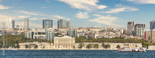 View from Bosporus strait of Dolmabahce Palace, or Dolmabahce Sarayi, located in Besiktas district on the European coast of Istanbul, Turkey photo