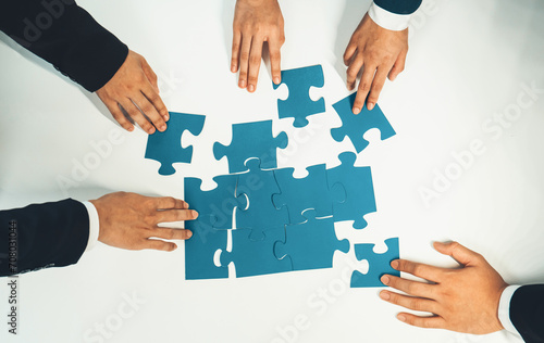 Top view panorama banner of business team assembling jigsaw puzzle over table symbolize business partnership and collective teamwork for HR recruitment and job seeker background. Shrewd