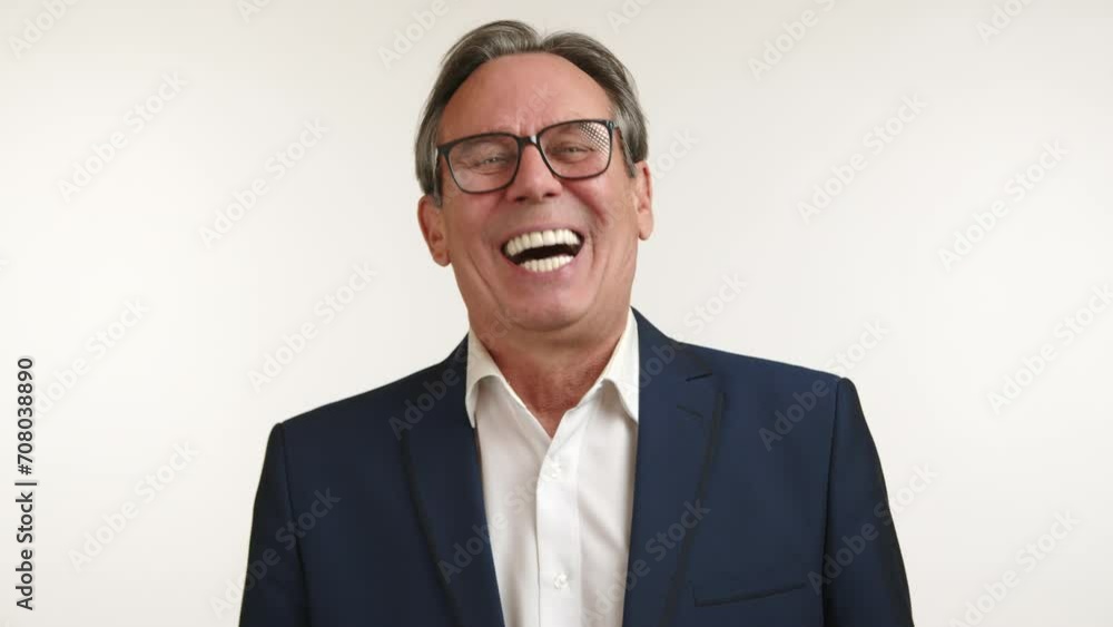 Elderly executive in a suit laughing heartily against a plain background, evoking a sense of genuine happiness and business casualness. Camera 8K RAW. Elderly executive in a suit laughing heartily against a plain background, evoking a sense of genuine happiness and business casualness. Camera 8K RAW.