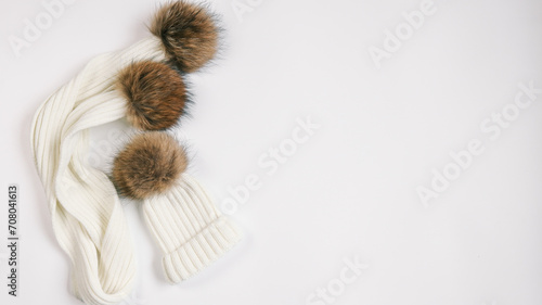 Stylish hat and scarf on white background, top view