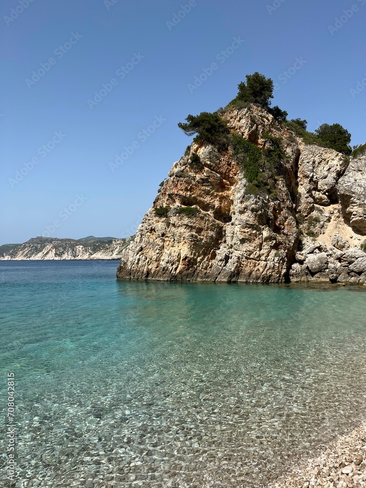 Fototapeta premium Agia Eleni beach, Kefalonia, Greece. Clear blue waters of Ionian Sea and mountain coastline