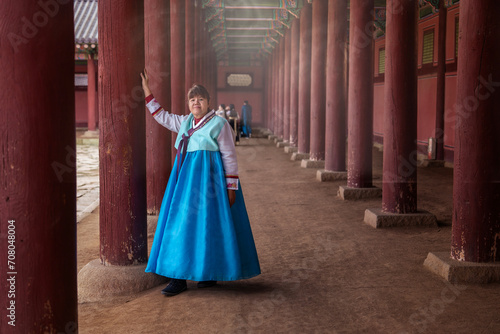 Female Asian tourist wearing traditional hanbok costume walking tours Gyeongbokguk Palace, South Korea. © Supavadee