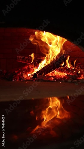 Wood is burning in a pizza oven. Close-up