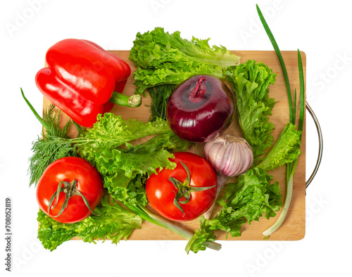 Vegetable still life. Tomatoes, garlic, onions, peppers, greens on kitchen board. Vegetarian food.