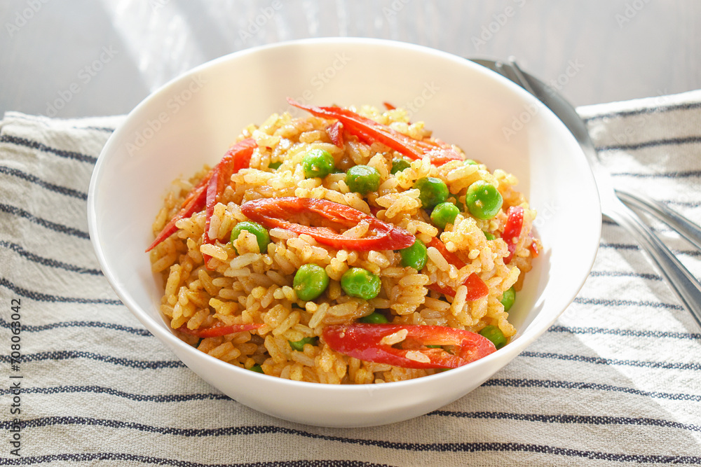 Spicy curry fried rice with sliced red chilli pepper and green peas. Healthy and dietary food. Spicy curry fried rice with sliced red chilli pepper and green peas. Healthy and dietary food.