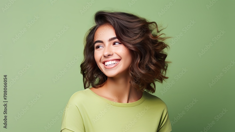 A portrait captures the beauty, happiness, cuteness, and smiling of a brunette woman who is dressed in casual green hipster summer clothes isolated on white. A portrait captures the beauty, happiness, cuteness, and smiling of a brunette woman who is dressed in casual green hipster summer clothes isolated on white.