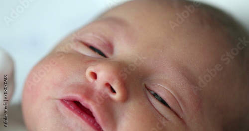 Newborn baby close-up face crying, first day of life