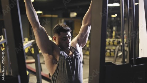 Lat Pulldown, Male bodybuilder doing weight lifting workout at gym. photo