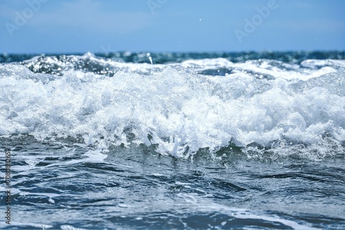 Blue sea wiht wave and blue sky background. Summer sea and blue sky.