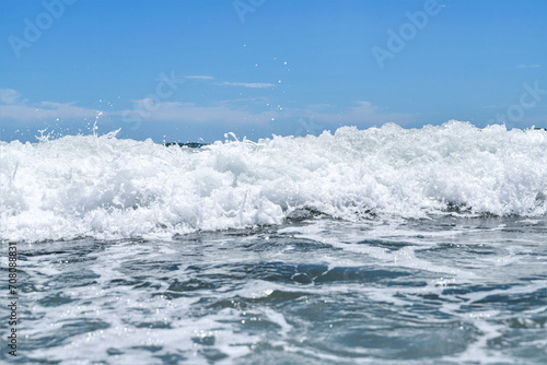 Blue sea wiht wave and blue sky background. Summer sea and blue sky.