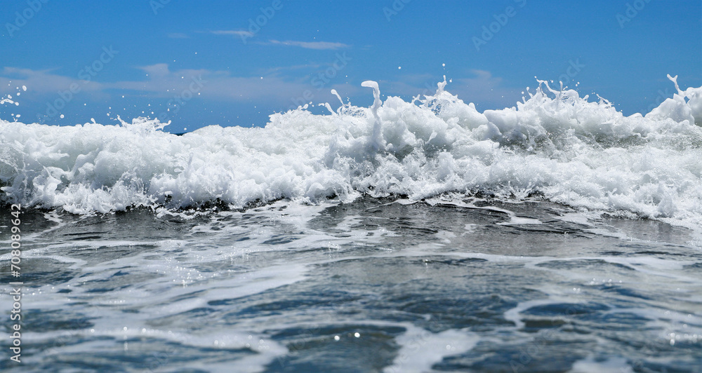 Blue sea  wiht wave and blue sky background. Summer sea and blue sky.