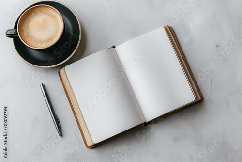 Clean Open Notebook with Coffee and Plant on White Marble for Creative Projects photo