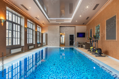 Magnificent private indoor swimming pool with mirrored ceiling and large windows. © alhim