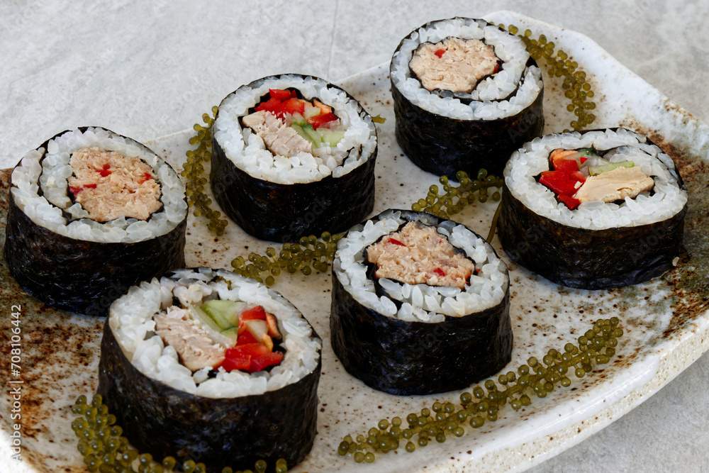 Homemade tuna futomaki maki sushi roll with Umibudo seaweed. Homemade tuna futomaki maki sushi roll with Umibudo seaweed.