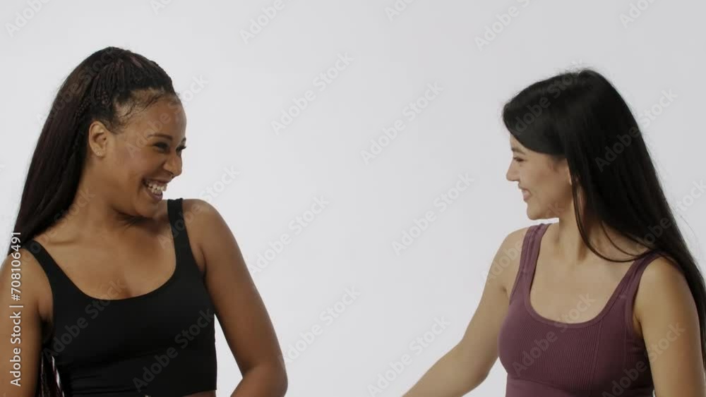 Portrait of multiethnic models isolated on white background, close shot. Group of two young multiracial girls posing and hugging at the camera. Multiethnic beauty concept. Portrait of multiethnic models isolated on white background, close shot. Group of two young multiracial girls posing and hugging at the camera. Multiethnic beauty concept.