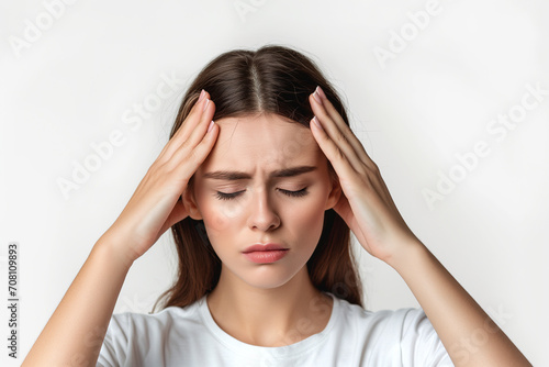 Woman with migraine holding her head and experiencing pain on white background photo