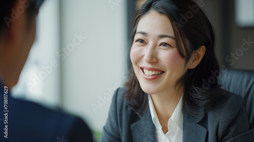 Japanese Businesswoman in Job Interview: Candid Meeting, Recruitment Talk, Manager and Candidate Discussion, Happy HR Management Interaction, Middle Aged Professional Negotiation, Business People Enga photo