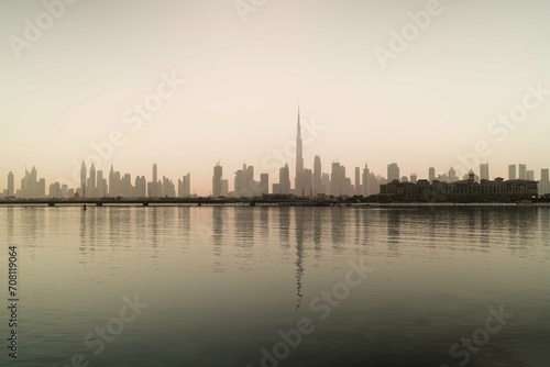Skyline of Dubai reflecting in the water photo