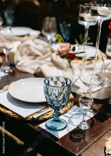Elegant table setting with a blue crystal glass.
