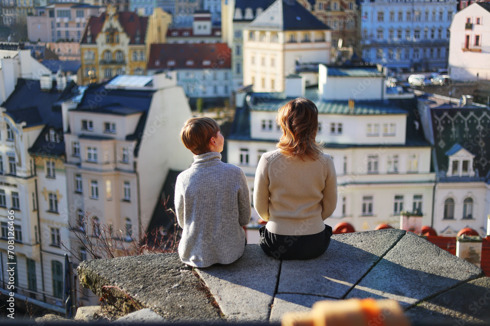 Family mom and son sitting and look on the view of Karlovy Vary