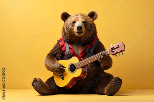 bear playing guitar while sitting on yellow background photo