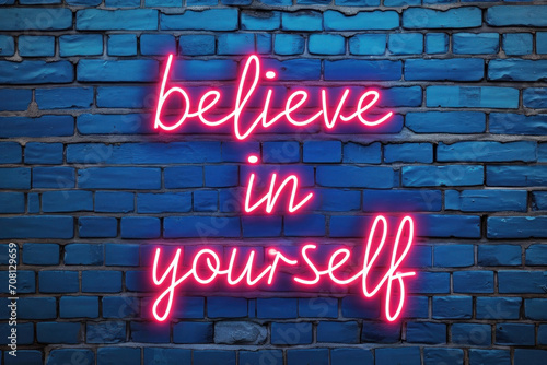 Plakat Empowering Neon Message on Brick Wall. 'Believe in Yourself' neon sign offers inspiration against a textured blue backdrop