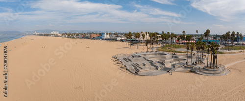 Skate board park in Venice beach with people skating by the Pacific ocean. Best and most popular skate park in the world. photo