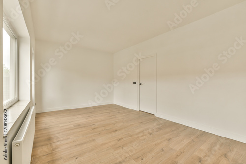 a living room with a wood floor and white walls photo