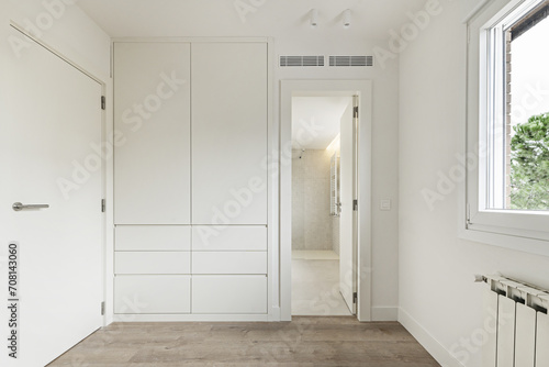 A walk-in closet next to an en-suite bathroom