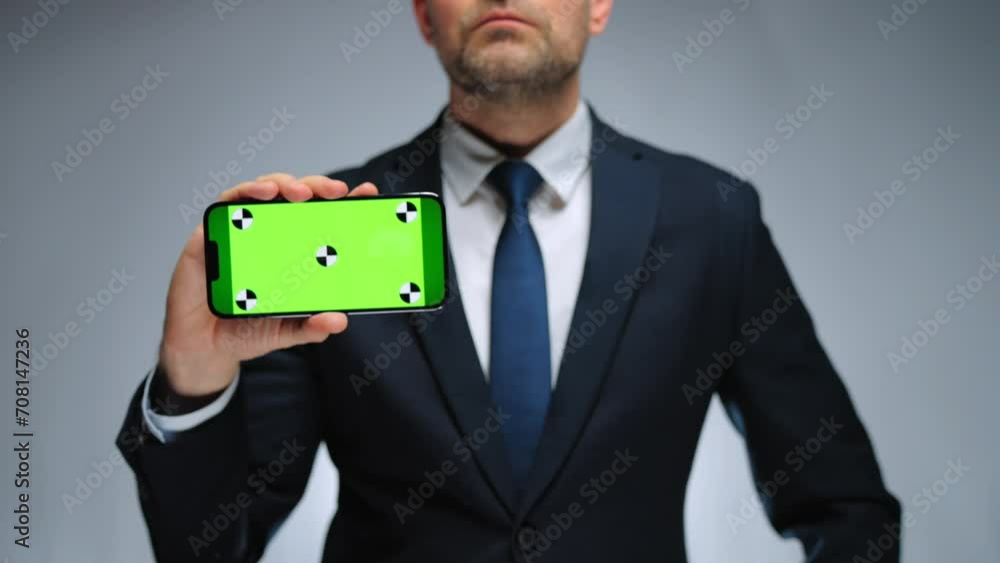 Man shows smartphone with green screen chroma key smartphone on camera. Man shows smartphone with green screen chroma key smartphone on camera.