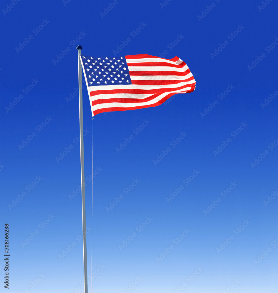 the national flag of the United States of America, USA, stars and stripes, on a flag pole flapping fluttering in the wind, blue sky the national flag of the United States of America, USA, stars and stripes, on a flag pole flapping fluttering in the wind, blue sky