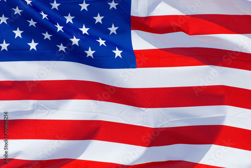 the national flag of the United States of America, USA, stars and stripes, flapping fluttering in the wind,