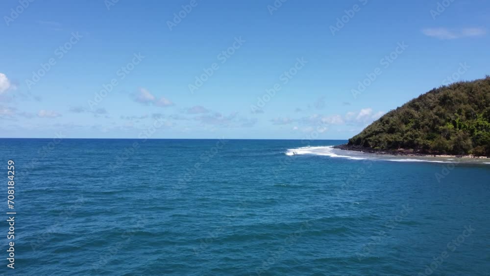 Drone flying over deep blue ocean water near the tropical island of Kauai in Hawaii. Drone flying over deep blue ocean water near the tropical island of Kauai in Hawaii.