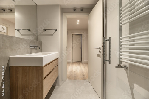 A bathroom with a modern design hanging wooden