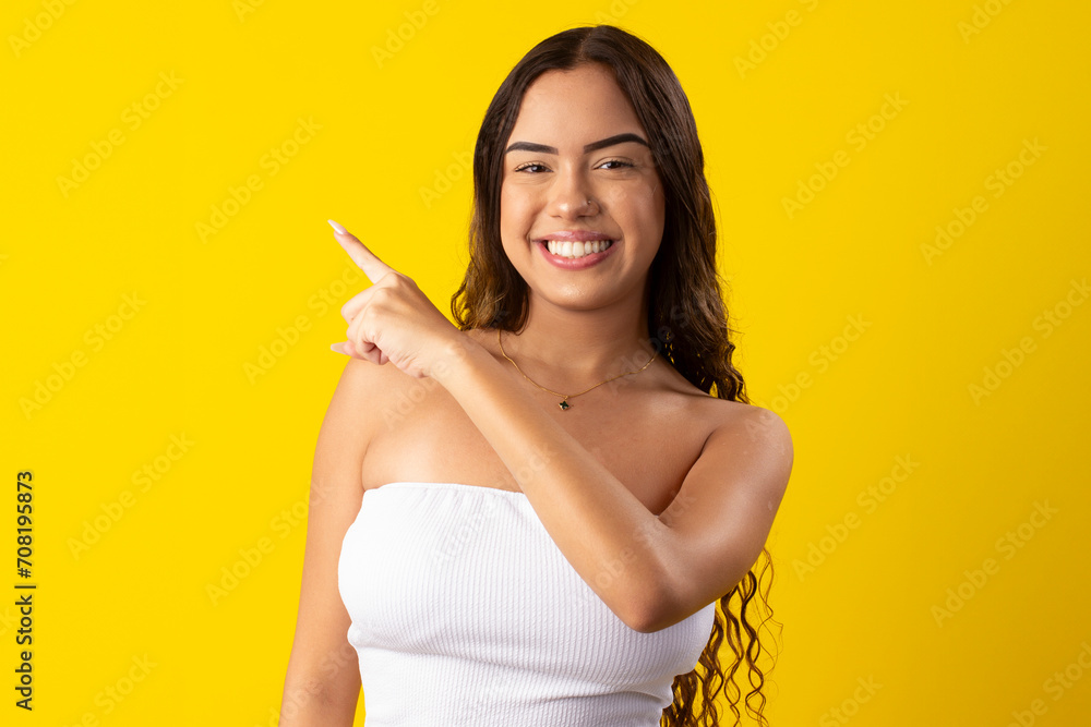Happy young woman wearing a white dress on a yellow background Happy young woman wearing a white dress on a yellow background