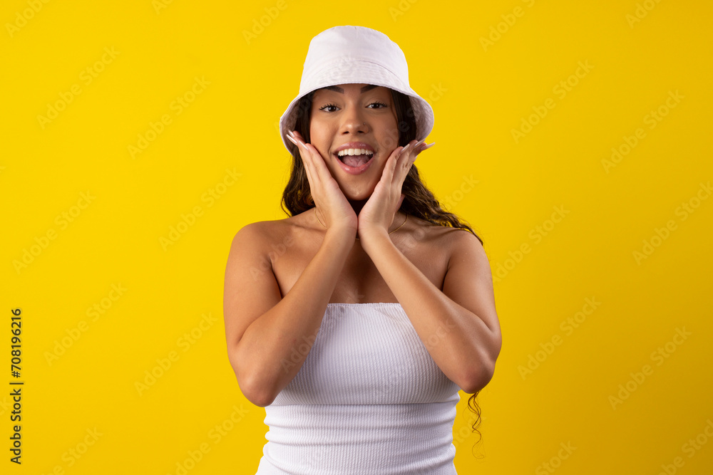 Happy young woman wearing a white dress on a yellow background Happy young woman wearing a white dress on a yellow background